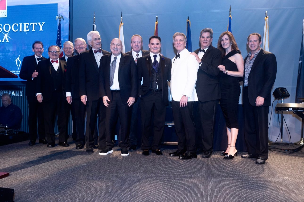 Dr. Angelo Cuzalina in a formal group photograph with past presidents of the American Academy of Cosmetic Surgery, New Orleans, 2024