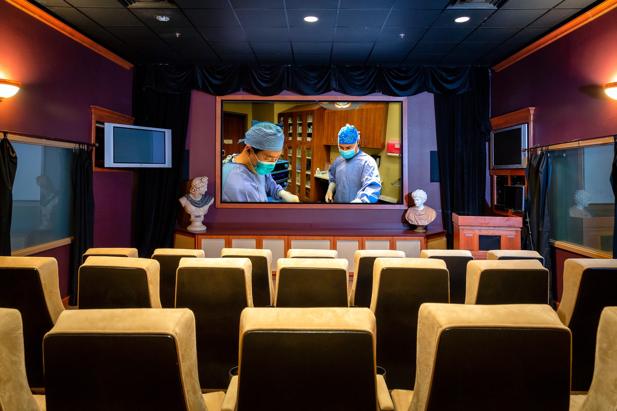 The observation theater at Tulsa Surgical Arts: rows of seats facing a window into an operating room